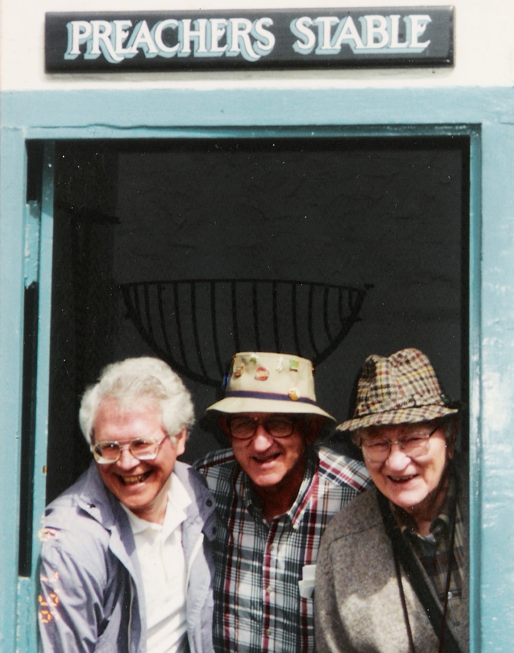 Brethren in Christ educators Luke L. Keefer Jr., Al Long, and Arthur Climenhaga pose for a lighthearted picture while on a tour of England in 1993. (Brethren in Christ Historical Library and Archives)