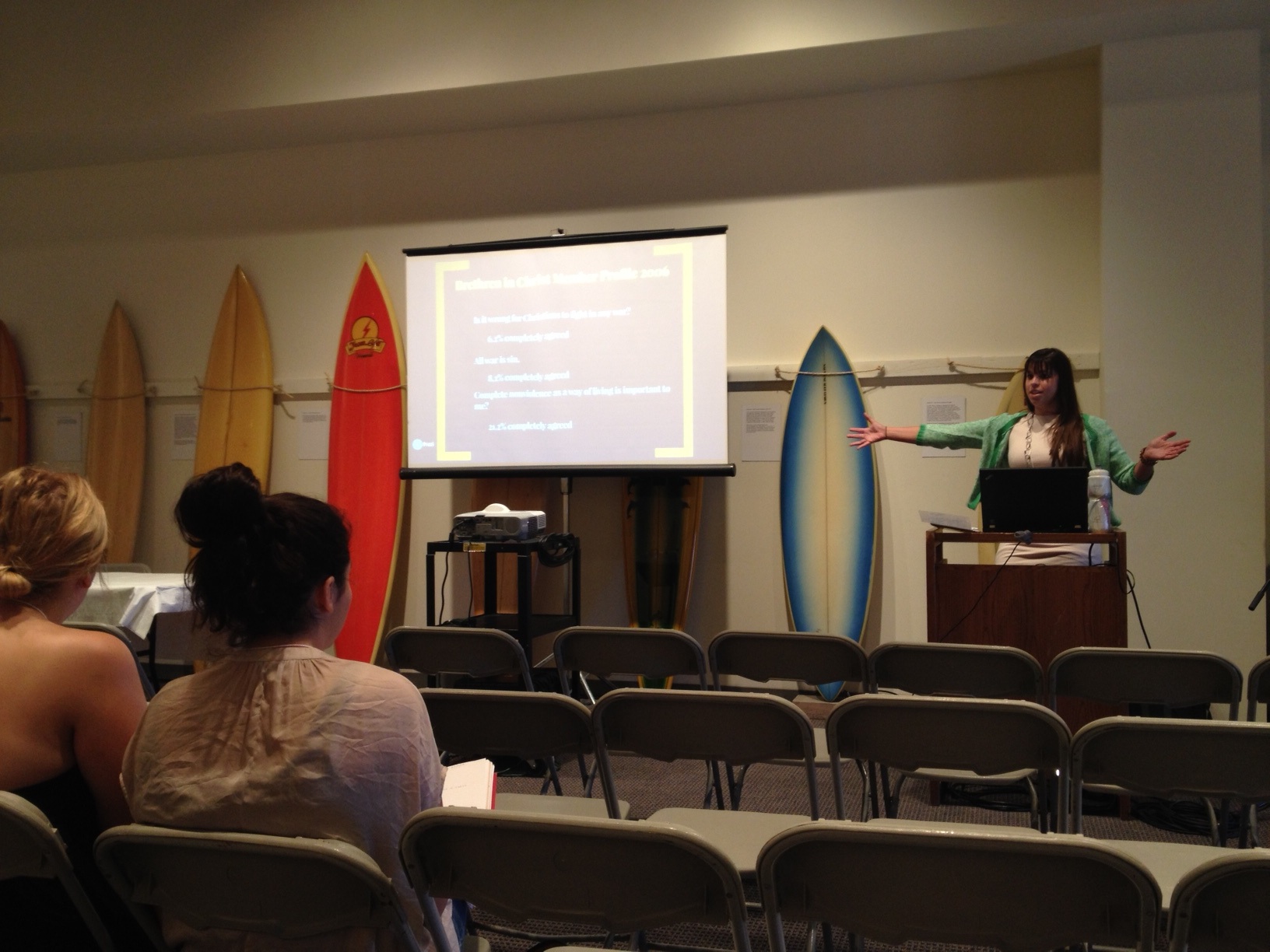 Former Messiah College student Brooke Strayer giving a presentation on the history of the Brethren in Christ peace position at the 2014 Conference on Faith and History undergraduate research conference. Yes, those are surfboards behind her -- she's presenting in the Pepperdine University Surfboard Museum!